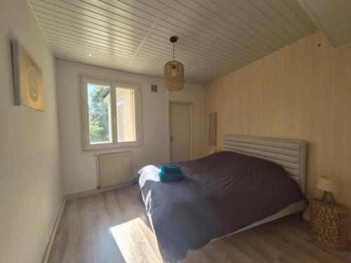 a bedroom with a bed and a window at #L'Instant#Terrasse #Thiers# in Thiers