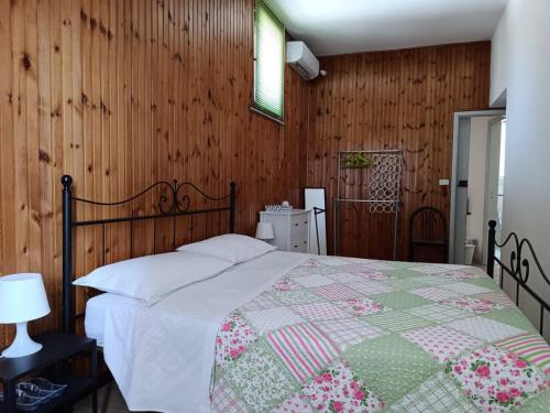 a bedroom with a bed and a wooden wall at La segreteria in Acireale