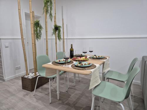 a dining room with a table with chairs and wine glasses at Pêra Holiday House in Pêra