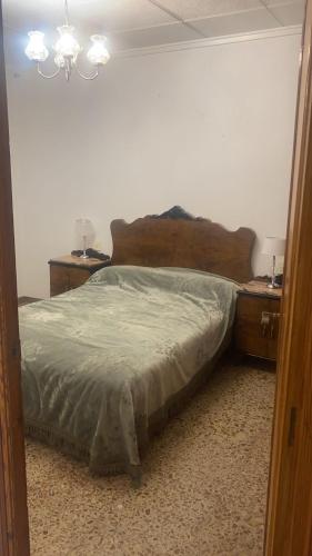 a bedroom with a large bed with two night stands at Appartement Spacieux fonctionnel Parking assuré!! in Novelda