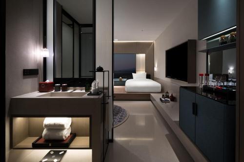 a bathroom with a sink and a mirror and a sink at Qianzitong First Seeing Hotel in Changping