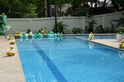 a swimming pool with a bunch of balloons in the water at Don Arc White Beach Resort in Initao