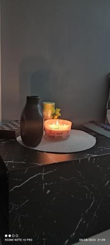 a table with a candle and a vase on it at Andriannas apartment-parking lot included in Patra