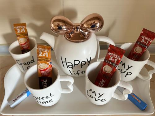 a tray with coffee cups with happy new year mugs at Pahira Lux in Paraćin