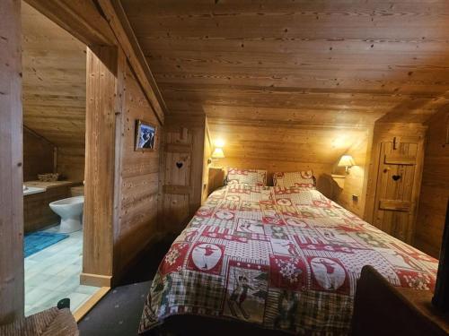 une chambre avec un lit dans une cabane en bois dans l'établissement Bel appartement tout en bois dans un chalet, à Megève