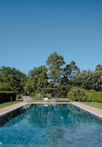a swimming pool with a table and chairs at Agriturismo Canova - Private Villas in Marina di Grosseto