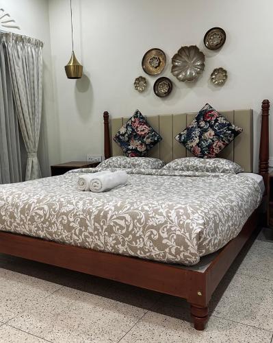 a bed with two towels on it in a bedroom at Mayilveedu Guest House in Tuticorin