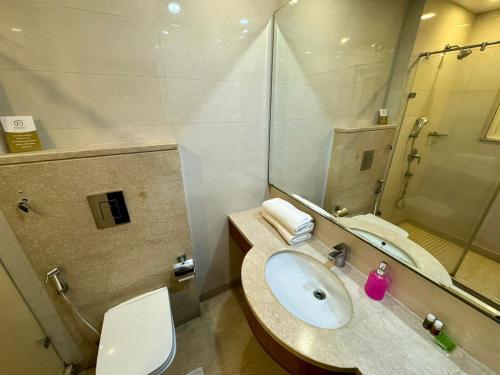 a bathroom with a sink and a toilet and a mirror at Hotel Florence Inn, Karol Bagh, New Delhi, 2 Min from Metro in New Delhi
