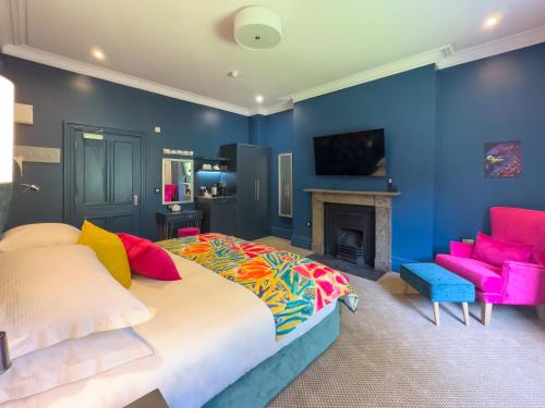 a blue bedroom with a bed and a fireplace at Dunningwell Hall in Duddon