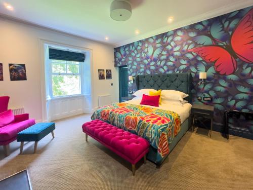 a bedroom with a large bed and a red bench at Dunningwell Hall in Duddon