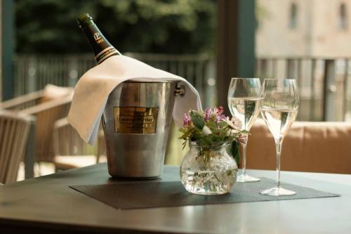 a bottle of champagne and two glasses on a table at Schlosshotel Blankenburg in Blankenburg