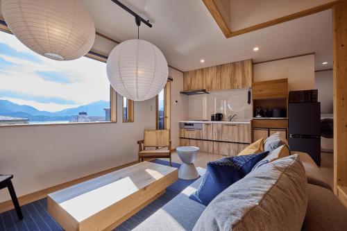 a living room with a couch and a table at 富士暁月湖凪Konagi in Fujikawaguchiko