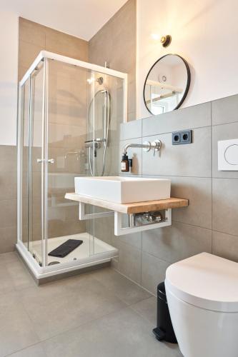 a bathroom with a shower and a sink and a toilet at Alte Seifensiederei - Thay in Bad Tölz