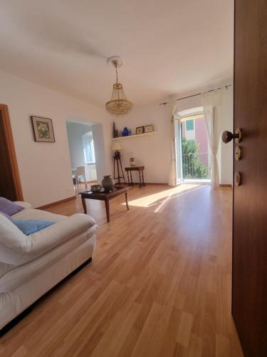 a living room with a white couch and a wooden floor at Casa Giulia in Genoa
