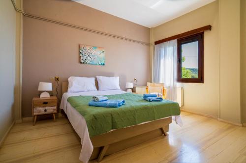 a bedroom with a bed with two towels on it at Ilia house in Volos