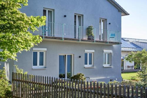 a blue house with a fence in front of it at Alte Seifensiederei - Viktor in Bad Tölz