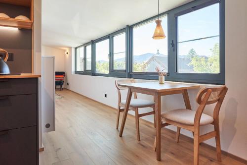 a kitchen and dining room with a table and chairs at Alte Seifensiederei - Lallaji in Bad Tölz