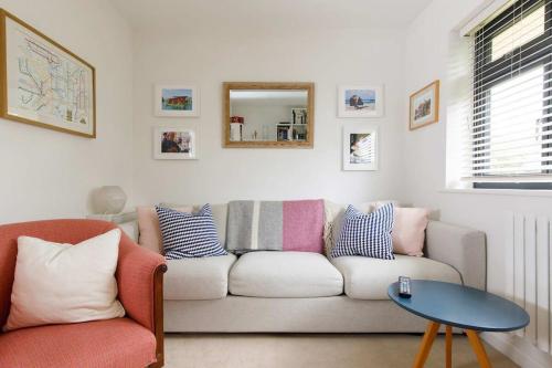 a living room with a couch and a table at Pretty Coastal Home in Bosham Close to Water in Bosham
