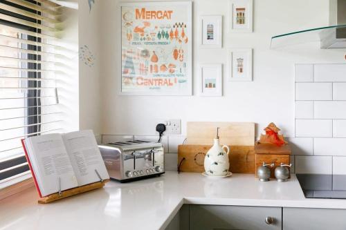 a kitchen with a counter with a toaster and a stove at Pretty Coastal Home in Bosham Close to Water in Bosham