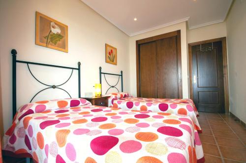 a bedroom with a bed with a polka dot blanket at RELAX en Vera Playa con SPA in Vera