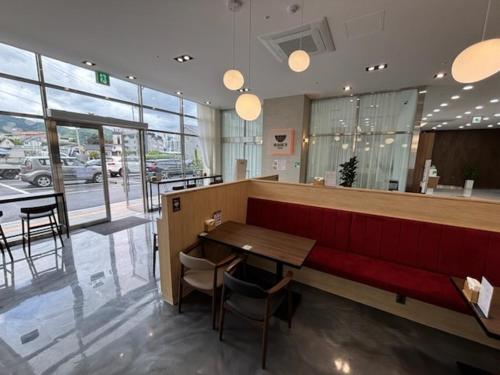 a restaurant with a red bench and a table at 어라연 관광호텔 영월 in Yeongwol