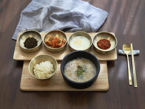 a tray with four bowls of food on a table at 어라연 관광호텔 영월 in Yeongwol