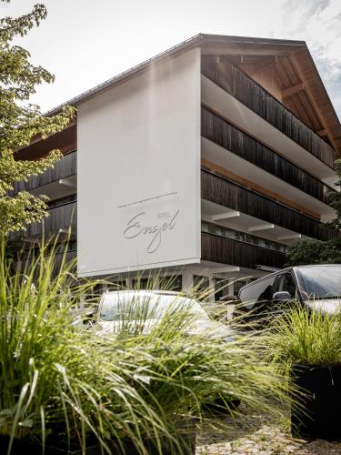 a building with cars parked in front of it at Hotel Engel in Mellau