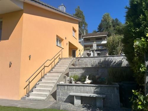 a building with stairs and a bench next to it at Residenza San Remy in Unterkulm