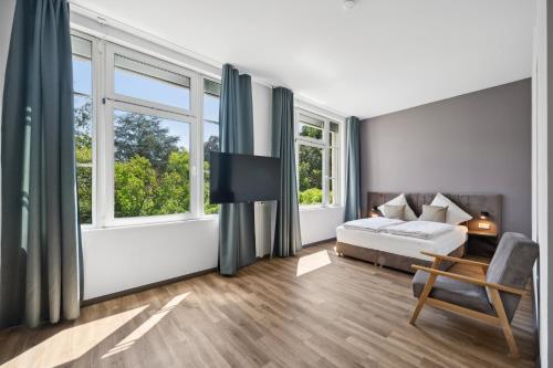 Una cama o camas en una habitación de Home and CoLiving Bonn I Aparthotel