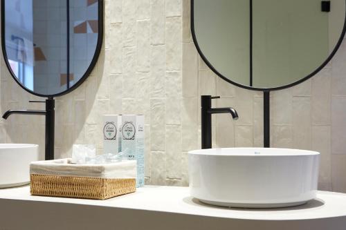 a bathroom with a sink and a mirror at 1881 Hotel Balneario Vichy Catalan in Caldes de Malavella