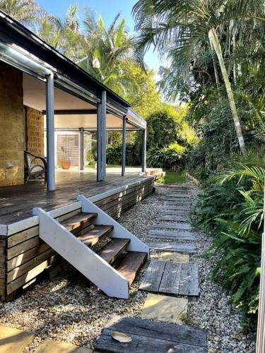 a porch of a house with a bench on it at Beachside 4 bedroom Home in Emerald Beach in Emerald Beach