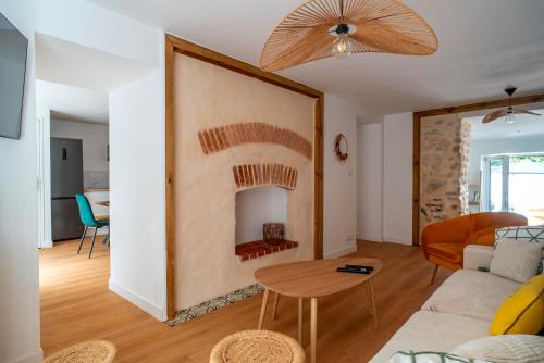 a living room with a fireplace in the wall at L'Écrin d'Hennebont - Maison en pierre pour 8 in Hennebont