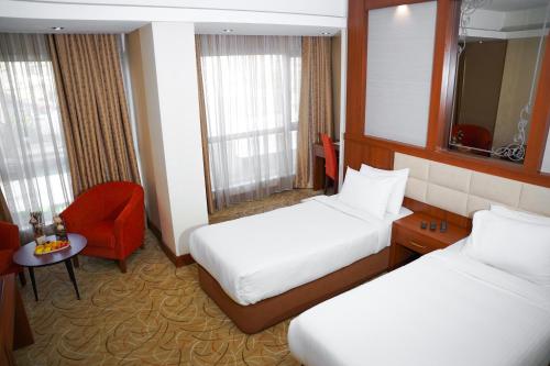 Ένα ή περισσότερα κρεβάτια σε δωμάτιο στο Shaheen Hotel Baghdad
