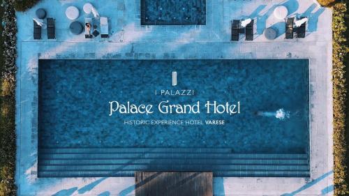 a sign for a palace grand hotel next to the water at Palace Grand Hotel Varese in Varese