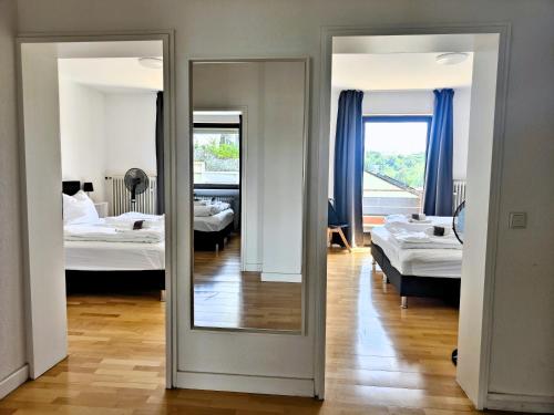 a room with two beds and a mirror at Großzügiges Ferienhaus in ruhiger Lage in Würzburg