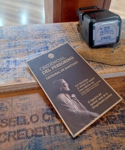a book sitting on a table next to a toaster at Hotel Jakue in Puente la Reina