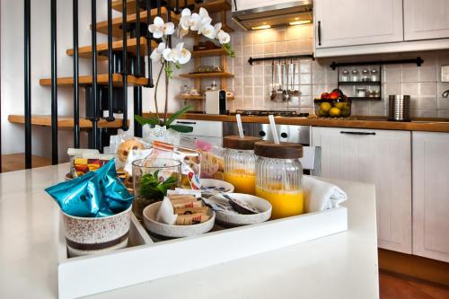 a kitchen counter with a tray of food and orange juice at Maia Home Grottaferrata in Grottaferrata