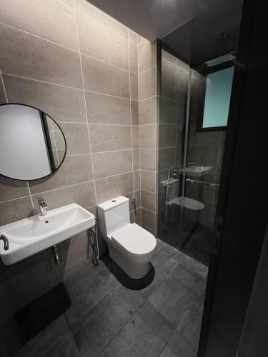 a bathroom with a toilet and a sink and a shower at Cosy studio at Setiawangsa, KL in Kuala Lumpur