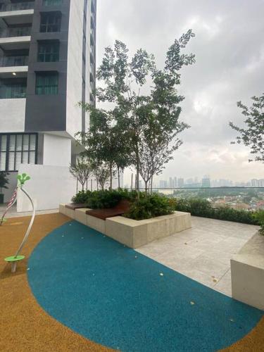 a blue carpet in front of a building with trees at Cosy studio at Setiawangsa, KL in Kuala Lumpur