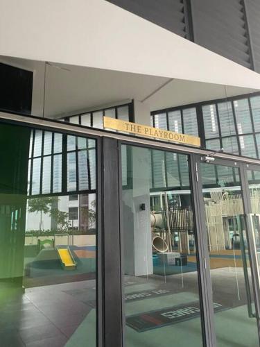 a building with a sign on top of a glass door at Cosy studio at Setiawangsa, KL in Kuala Lumpur