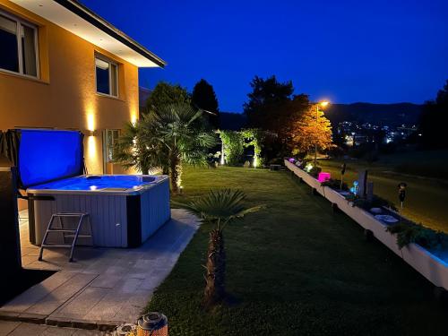 a backyard with a hot tub next to a house at Residenza San Remy in Unterkulm