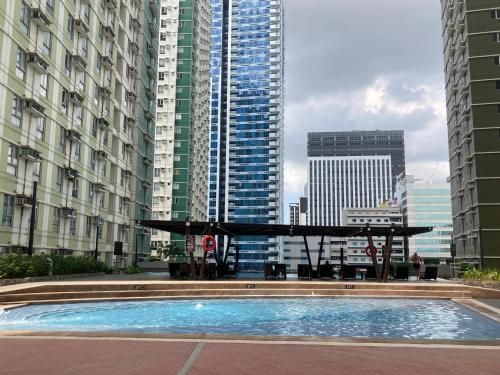 a swimming pool in a city with tall buildings at Casa Florentine, Avida Towers Riala Tower 4, IT Park in Cebu City