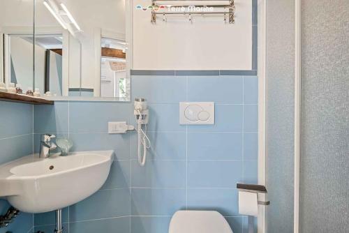 a blue bathroom with a sink and a toilet at Lover's Lane 1, TerreMarine in Riomaggiore