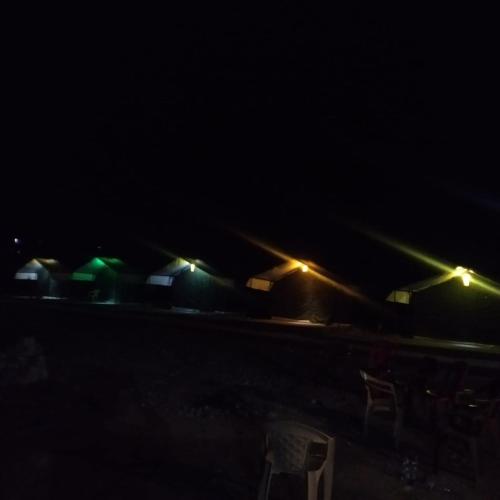 a group of buildings with lights in the dark at Ladakh Mountian Escape Camp by LexStays in Leh