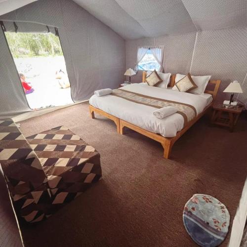 a bedroom with a large bed in a tent at Ladakh Mountian Escape Camp by LexStays in Leh