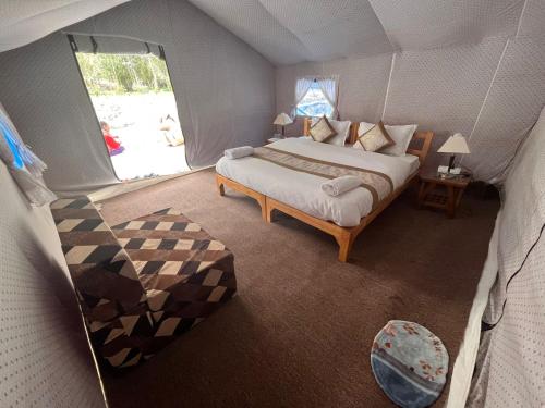 a bedroom with a bed in a tent at Ladakh Mountian Escape Camp by LexStays in Leh