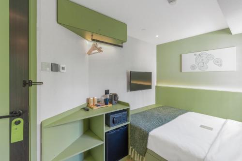 a small room with a bed and a desk at Urbanwood Hung Hom in Hong Kong