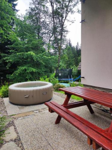 a dog bowl sitting next to a picnic table and a bench at Jezinka Dolní Morava in Dolní Morava