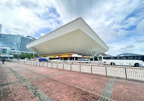 a large building in a city with a bus at Urbanwood Hung Hom in Hong Kong