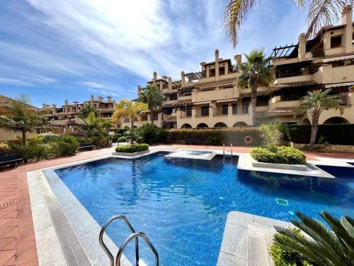 a large swimming pool in front of a building at Apartamento en Resort de lujo Isla del Fraile in Águilas